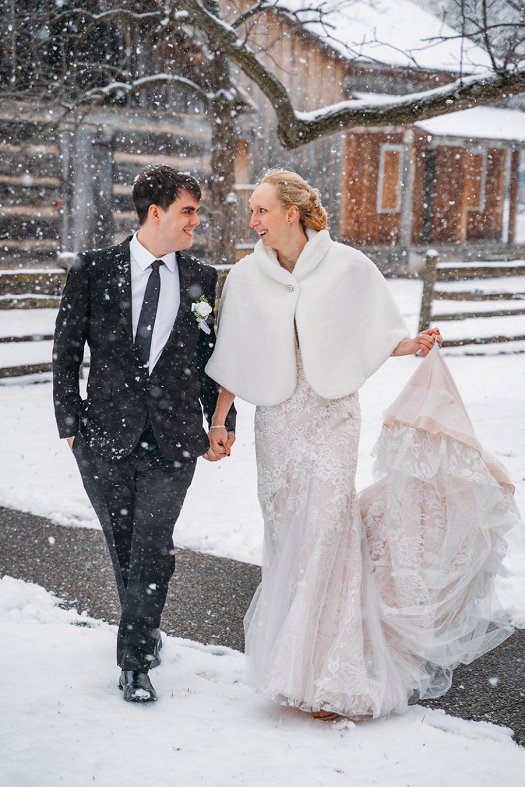 bride and groom walking in snow